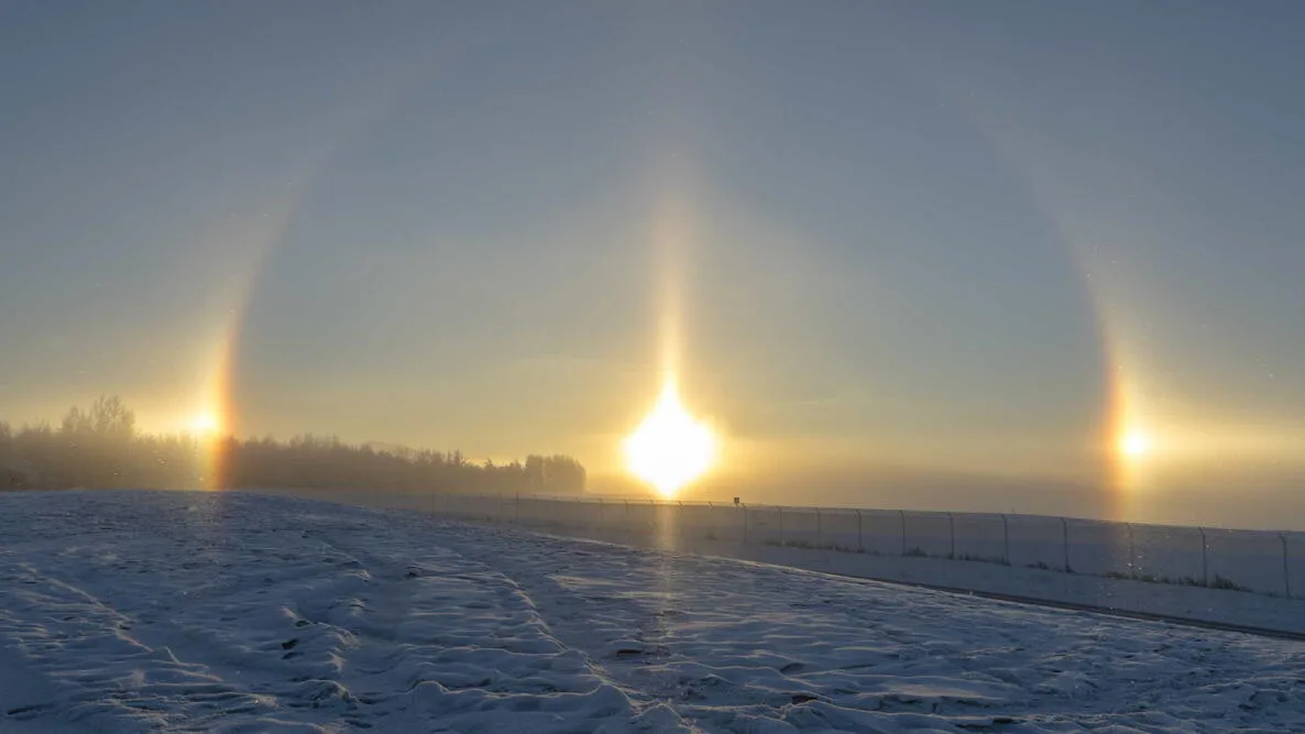 Parhelia, commonly known as sun dogs, are bright spots of light that appear on either side of the su