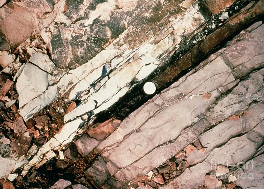 The thin, dark layer of iridium-rich clay known as the Cretaceous-Paleogene (K-Pg) boundary marks th