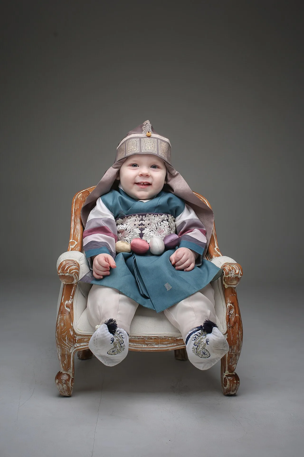 A baby participating in a Doljanchi ceremony in Korea, reaching for objects to predict their future profession or destiny.