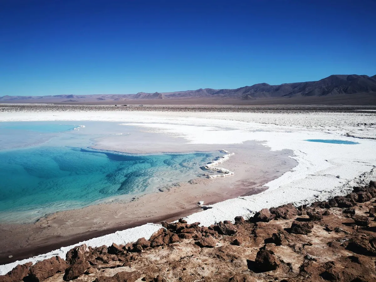 The vast, shimmering salt flats of the 'lithium triangle' in South America, particularly the Atacama