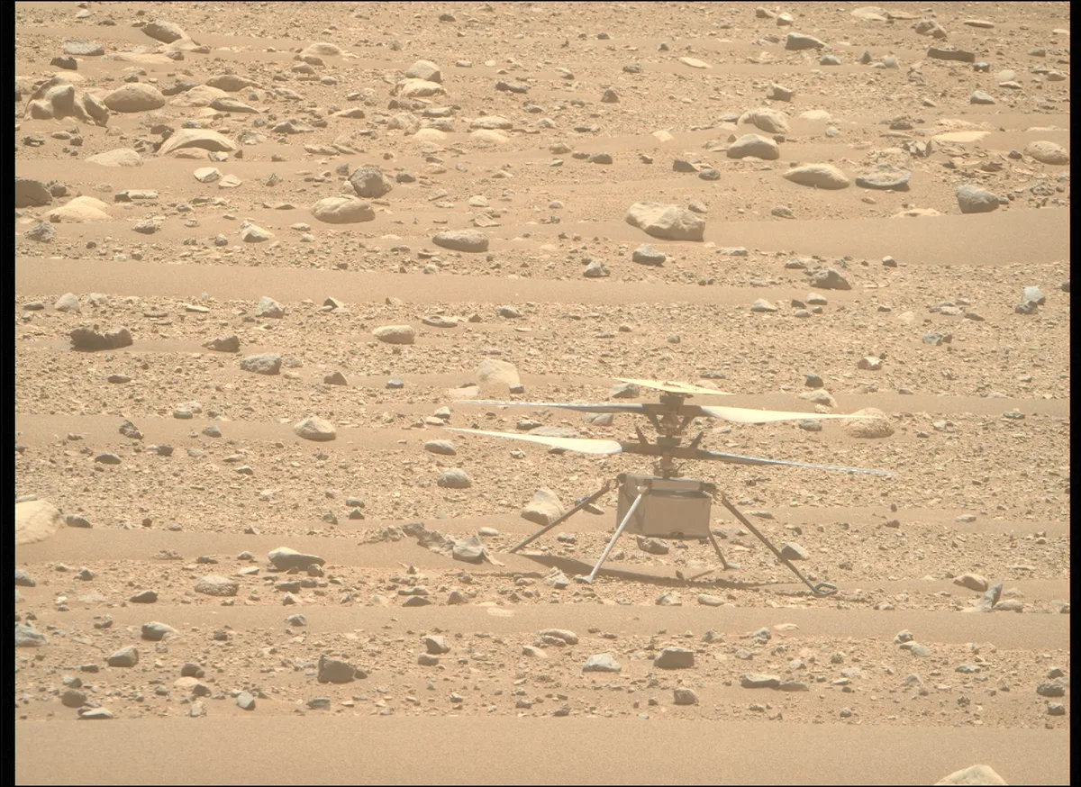 NASA's Ingenuity helicopter, seen here on the Martian surface, made history by achieving the first p