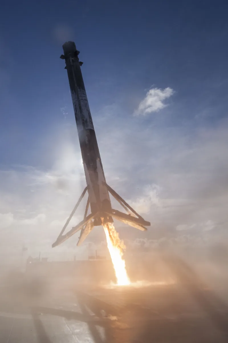 A SpaceX Falcon 9 rocket booster makes a historic vertical landing after delivering its payload to o