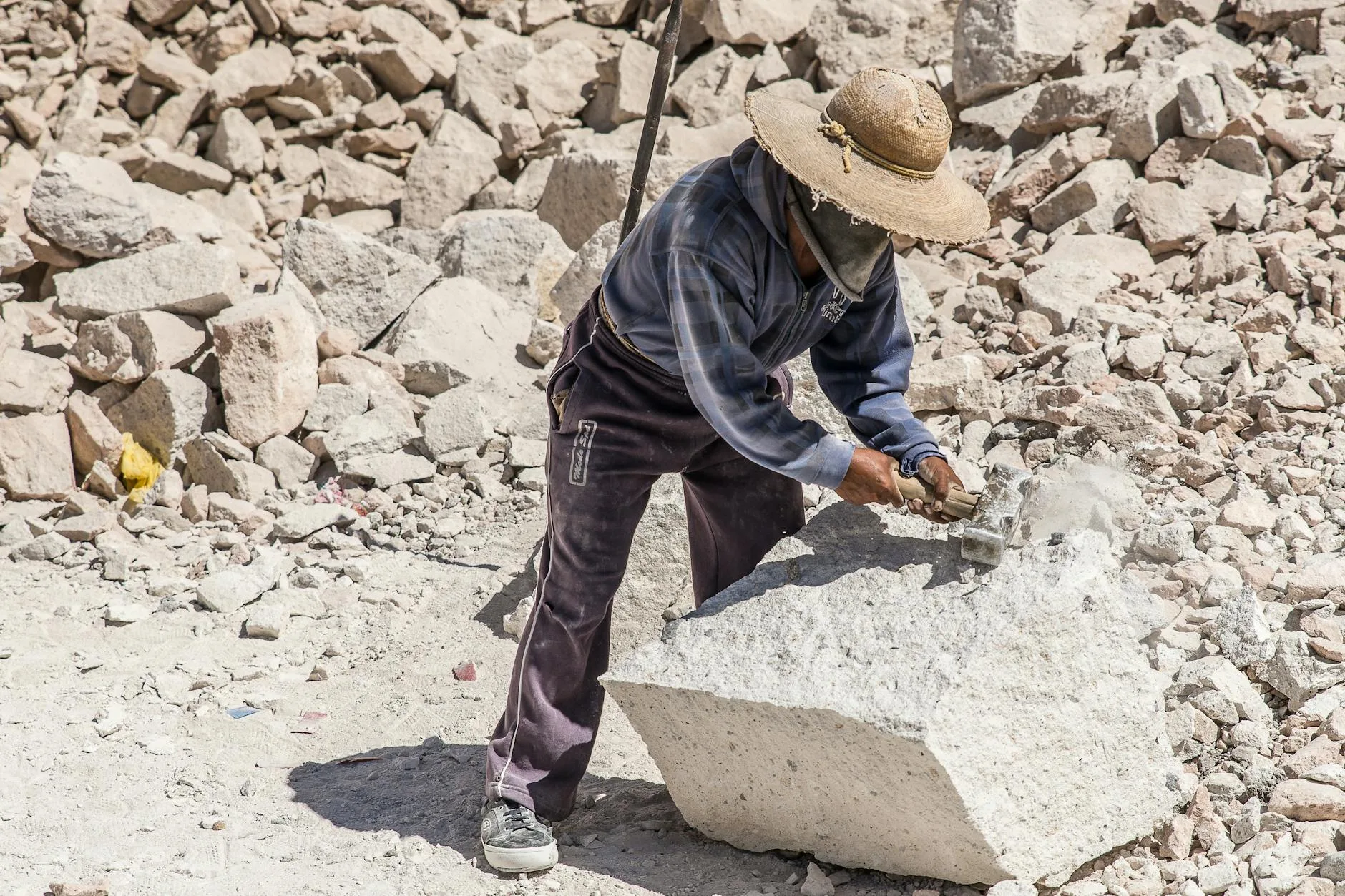 Lavoratori indiani estraggono quarzo in Rajasthan, in condizioni polverose.